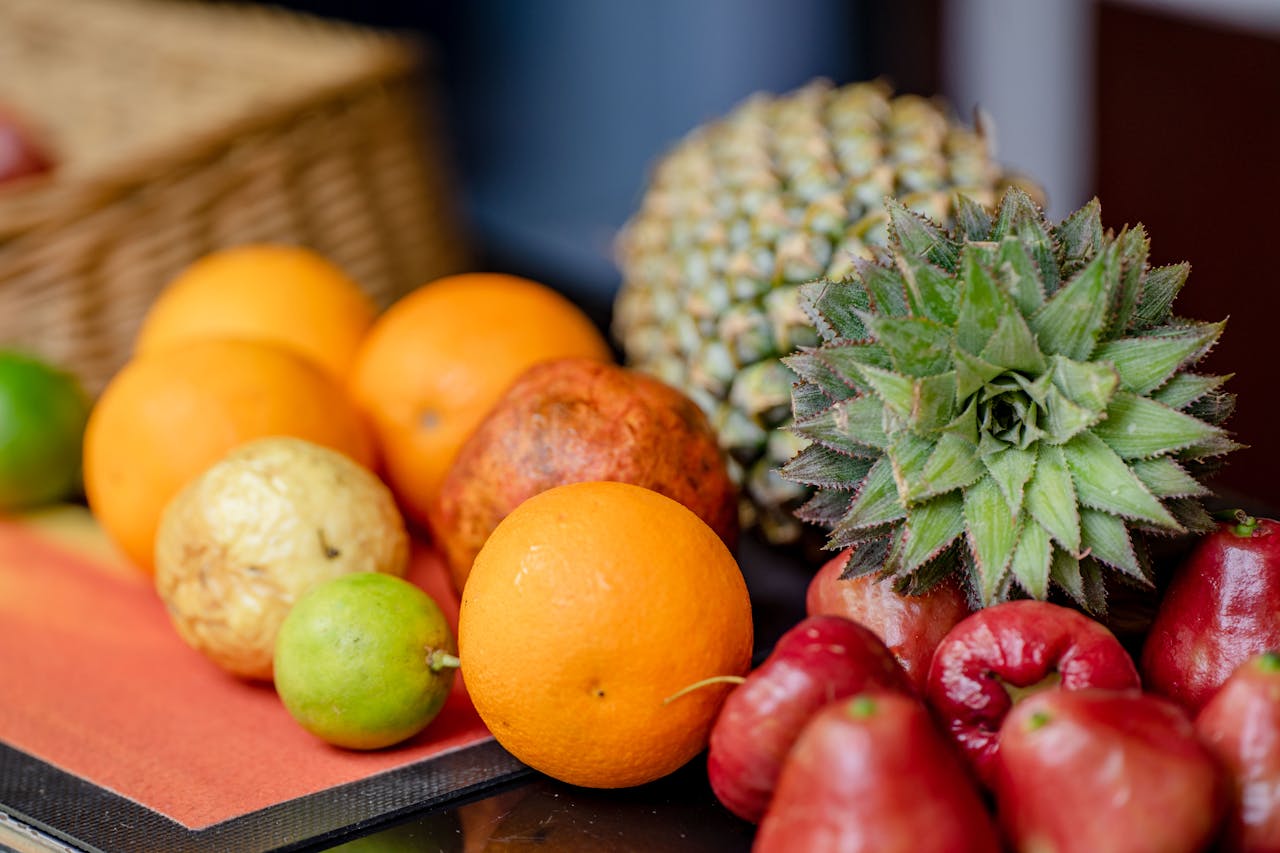 Home A vibrant assortment of fresh, organic fruits including oranges, pineapple, and apples, perfect for a healthy diet.