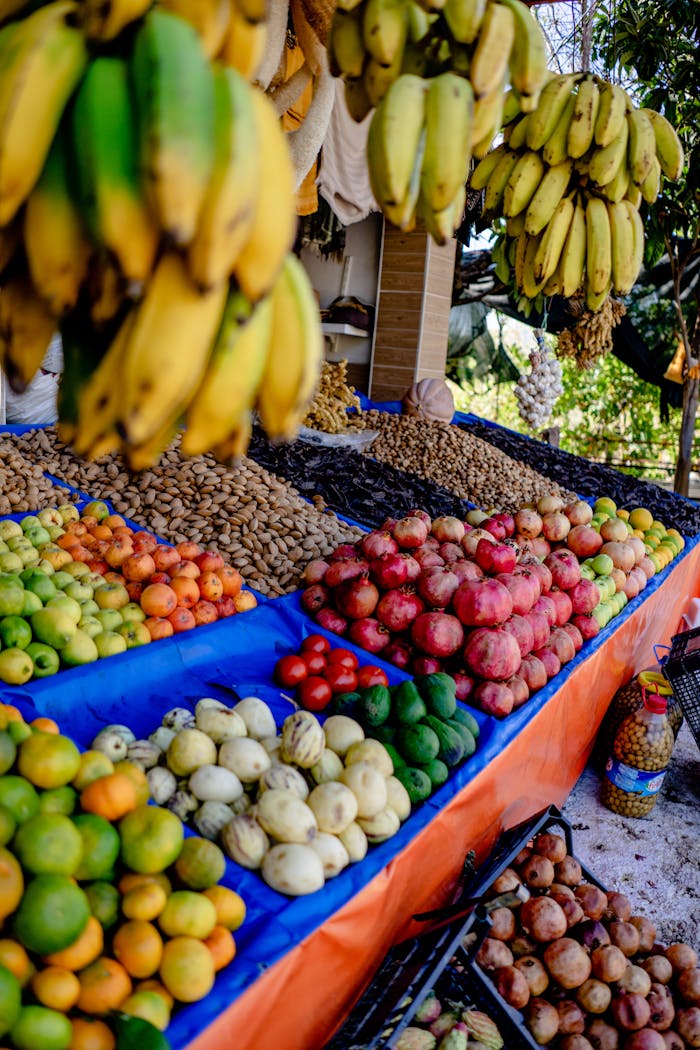 Home Colorful fruit market display with bananas, apples, oranges, and exotic fruits, showcasing freshness and variety.