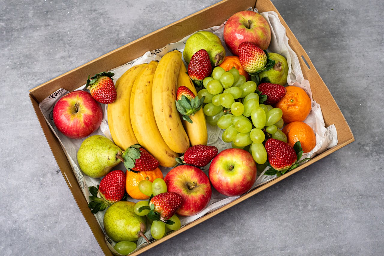 Home A delicious assortment of fresh fruits including apples, bananas, strawberries, and grapes.